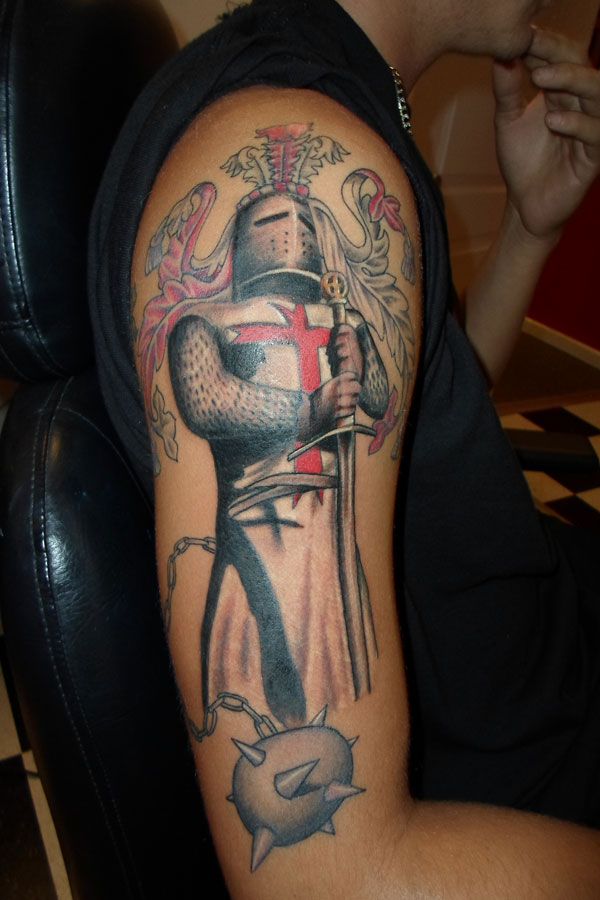 Color half sleeve tattoo of an armoured crusader knight holding a sword, with a red cross tabard, banner and spiked flail