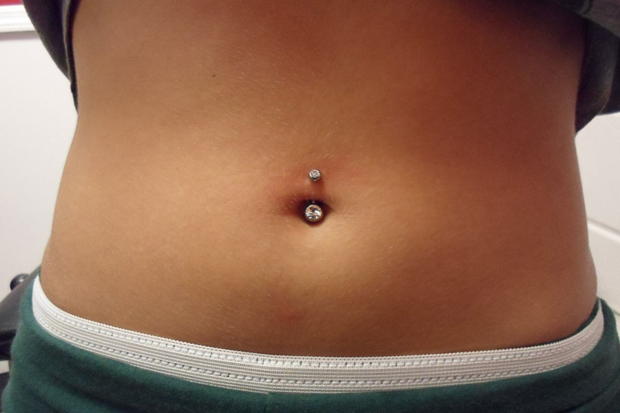 Healed navel piercing with a gemmed implant-grade titanium curved barbell